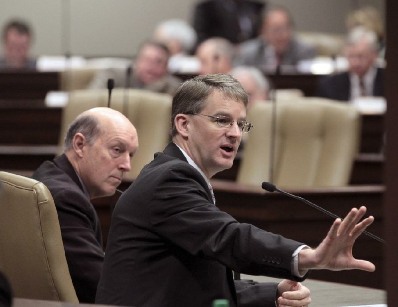 Department of Human Services Director John Selig (left) and Arkansas Medicaid Director Andy Allison testified Thursday before the Joint Budget Committee. Committee members voted to continue the state’s private-option program in fiscal 2015. 