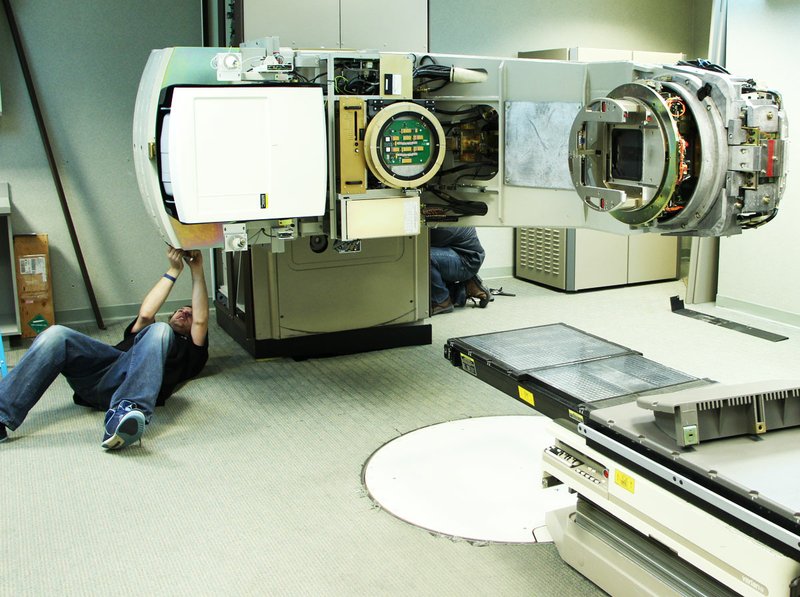 Members of the Varian crew disassemble the former linear accelerator at the White River Medical Center Cancer Care Center in Batesville to prepare for the installation of the Varian TrueBeam accelerator. Installation is expected to be complete in four to six weeks.