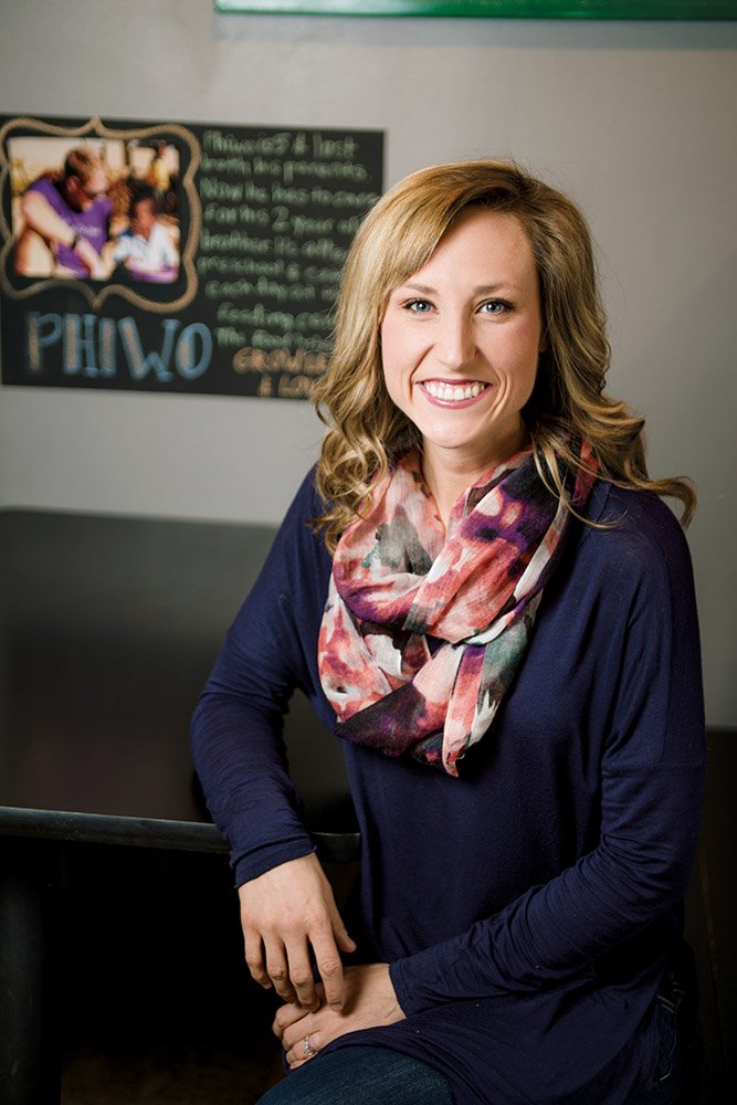 Ashton Samuelson sits in a booth at the restaurant at 2235 Dave Ward Drive in Conway that she and her husband, Austin, started in 2011 with a model she said no other restaurant was using at the time. For each meal purchased at Pitza 42, a meal is provided for a child through Feed My Starving Children, and thousands have been fed.