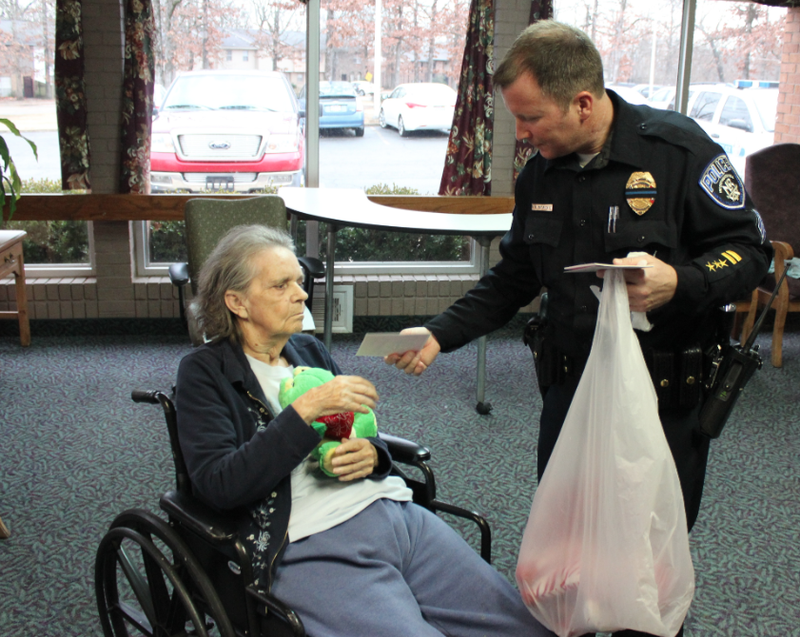 North Little Rock police Sgt. Brian Dedrick hands out a Valentine's Day stuffed toy and card Friday at Northridge Healthcare And Rehabilitation Friday. 