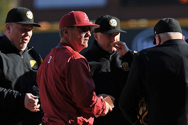 Arkansas baseball coach Dave Van Horn talks with the umpires before the start of the is season opener against Appalachian State Friday afternoon at Baum Stadium in Fayetteville.