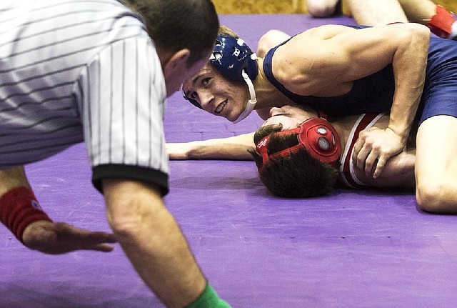 Southside Batesville’s Noah Woolery looks toward an official while trying to pin Glen Rose’s Adrian Shurtleff during the early rounds Friday in the 1A-5A state tournament at the Jack Stephens Center in Little Rock. Competition continues today with the semifinals starting at 9 a.m. and the finals scheduled to begin at 3:30 p.m. 