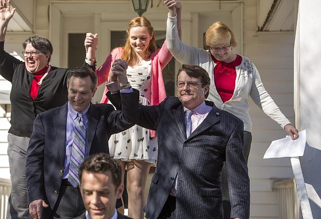 From left back row, Carol Schall , Emily Schall-Townley,16,  daughter of Schall and Townley and Mary Townley , Tim Bostic and Tony London celebrate the Thursday's ruling by federal Judge Arenda Wright Allen that Virginia's same-sex marriage ban was unconstitutional on Friday, Feb. 14, 2014 in Norfolk, Va.  Wright Allen on Thursday issued a stay of her order while it is appealed, meaning that gay couples in Virginia still wont be able to marry until the case is ultimately resolved. An appeal will be filed to the 4th District Court of Appeals, which could uphold the ban or side with Wright Allen. At the bottom of photo is Adam Umhoefer, Executive Director of the American Foundation for Equal Rights.  (AP Photo/The Virginian-Pilot, Bill Tiernan)  MAGS OUT