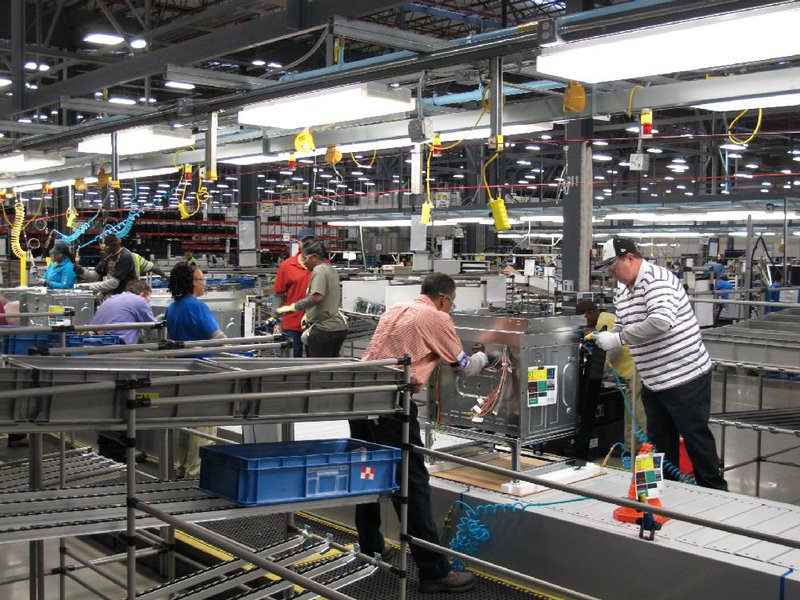 Workers assemble ovens at the Electrolux home-cooking appliance factory in Memphis last month. The Federal Reserve said cold weather slowed assembly lines last month, tempering production. 