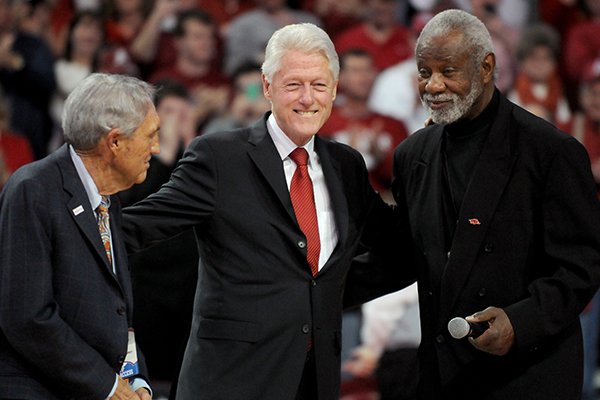 Eddie Sutton, President Bill Clinton and Nolan Richardson take part in a half-time ceremony in the game between Arkansas and LSU on Saturday February 15, 2014 in Bud Walton Arena in Fayetteville. 