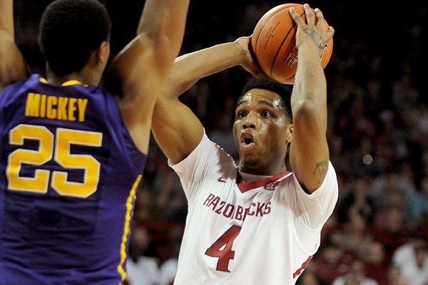 Arkansas's Coty Clarke looks to pass under pressure from LSU's Jordan Mickey during the game between Arkansas and LSU on Saturday February 15, 2014 in Bud Walton Arena in Fayetteville. 