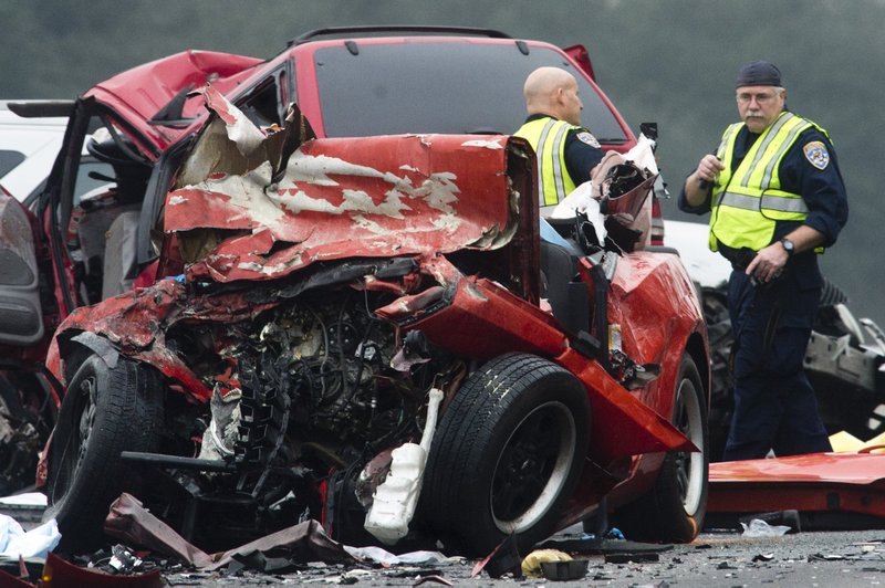 Officials investigate the scene of a multiple vehicle accident where six people were killed on the westbound Pomona Freeway in Diamond Bar, Calif., on Sunday morning. Authorities say four members of a family have been killed in the wrong-way freeway crash that also took the life of two others, including the sister of a woman arrested on suspicion of drunken driving.