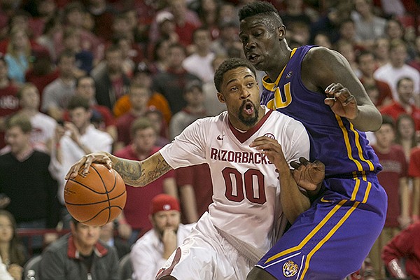 Arkansas guard Rashad Madden (00) drives to the basket against LSU forward Johnny O'Bryant III (2) during the second half of an NCAA college basketball game on Saturday, Feb. 15, 2014, in Fayetteville, Ark. (AP Photo/Gareth Patterson)
