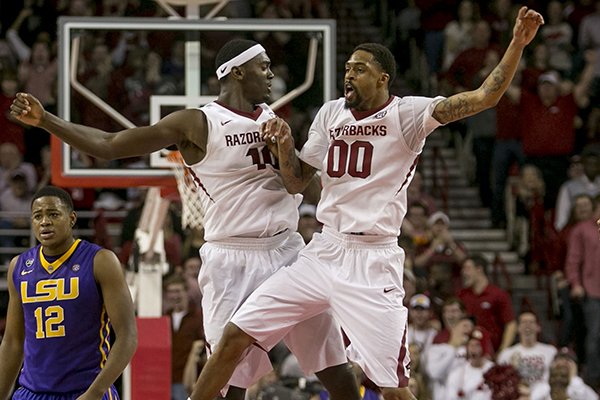 Arkansas forward Bobby Portis (10) and guard Rashad Madden (00) celebrate at center court after completing an alley-oop dunk during the second half of an NCAA college basketball game on Saturday, Feb. 15, 2014, in Fayetteville, Ark. Madden led all scorers with 21 points in Arkansas' 81-70 win. (AP Photo/Gareth Patterson)