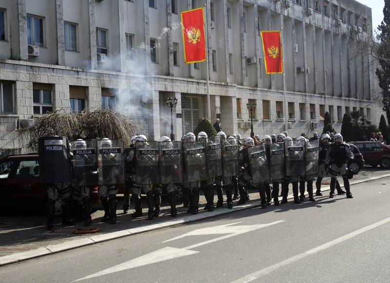 Montenegro police officers guard a government building during a protest in Podgorica, Montenegro, Saturday. The demonstrators who assembled in the downtown area of the capital, Podgorica, on Saturday demanded the resignation of the government of the long-standing prime minister, Milo Djukanovic. They accuse his government of rampant corruption, unemployment and economic mismanagement. 