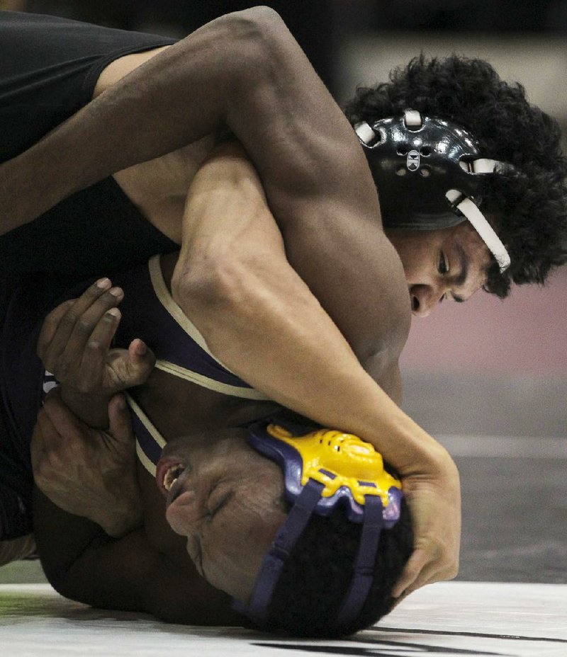 Arkansas Democrat-Gazette/BENJAMIN KRAIN --2/15/2014--
Maumelle's Willie Wright, top, defeated Central Arkansas Christian's Kyler CQ Simmons in the Class 1A-5A 152 weight division of the high school state wrestling tournamnet held this weekend at UALR.