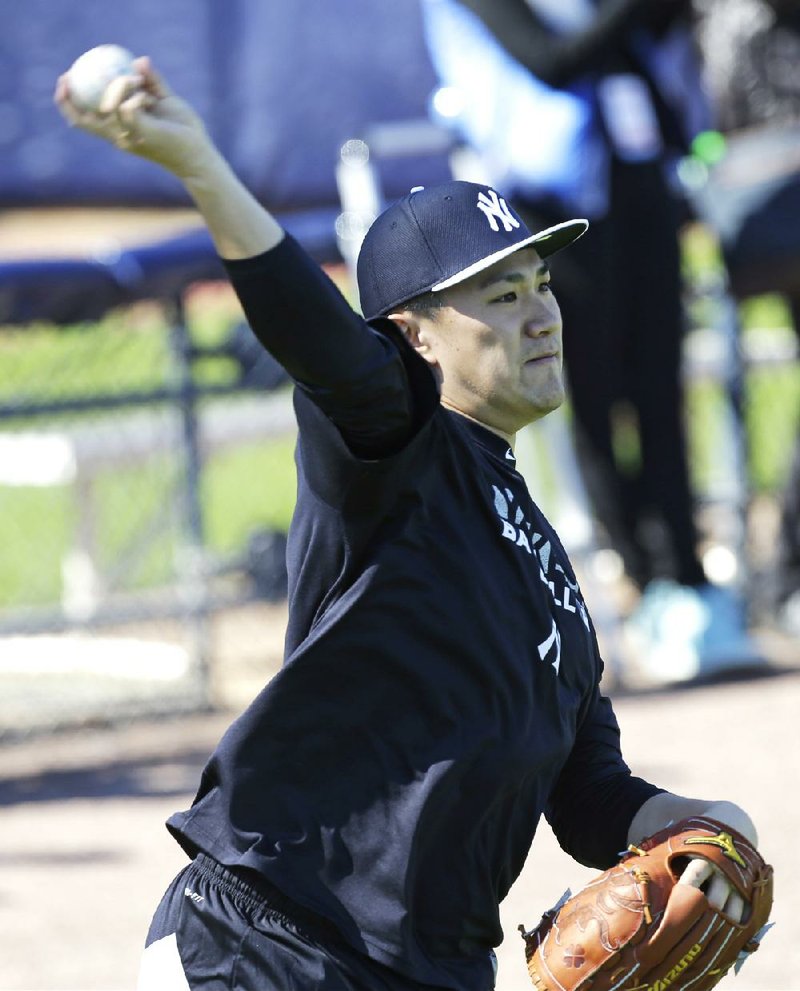 New York Yankees starting pitcher Masahiro Tanaka throws in the outfield during spring training baseball practice Friday, Feb. 14, 2014, in Tampa, Fla. (AP Photo/Charlie Neibergall)