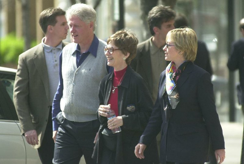 Diane Blair is flanked by Bill Clinton and Hillary Rodham Clinton as they make a stop on the square in downtown Fayetteville during an April 9, 2000, visit.


