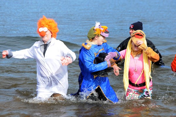Sara Kissinger, from left, Lindsay Varnes and Michele Oakley, dressed as Beaker, Floyd Pepper and Janice from The Muppets, react to the chilly water temperature Saturday, Feb. 15, 2014, at Prairie Creek Marina in Rogers during the annual Polar Plunge, an event benefitting Special Olympics Arkansas. Prizes were award to best costumes for groups, pairs and individuals along with prizes for most money raised.
