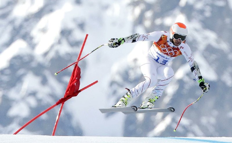 Joint bronze medal winner Bode Miller of the United States makes a jump in the men's super-G at the Sochi 2014 Winter Olympics, Sunday, Feb. 16, 2014, in Krasnaya Polyana, Russia. (AP Photo/Charlie Riedel)