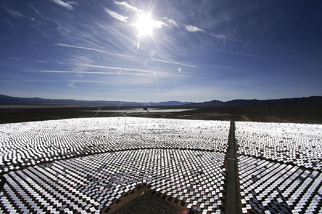 Some of the 300,000 computer-controlled mirrors, each about 7 feet high and 10 feet wide, reflect sunlight to boilers that sit on 459-foot towers. The sun's power is used to heat water in the boilers' tubes and make steam, which in turn drives turbines to create electricity Tuesday, Feb. 11, 2014 in Primm, Nev. The Ivanpah Solar Electric Generating System, sprawling across roughly 5 square miles of federal land near the California-Nevada border, will be opened formally Thursday after years of regulatory and legal tangles. (AP Photo/Chris Carlson)