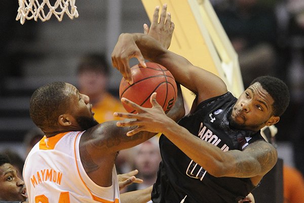 Tennessee forward Jeronne Maymon (34) and South Carolina guard Sindarius Thornwell (0) tangle for a rebound during the second half of an NCAA college basketball game Saturday, Feb. 8, 2014, in Knoxville, Tenn. Tennessee won 72-53. (AP Photo/Knoxville News Sentinel, Adam Lau)