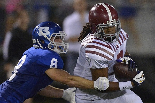 Pine Bluff tight end Will Gragg (right) catches a pass as Bryant linebacker David Nossaman (8) defends during the first quarter Friday, Oct. 4, 2013 in Bryant. 