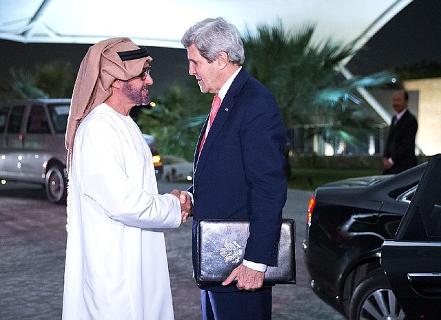 Secretary of State John Kerry is greeted by Crown Prince Sheikh Mohammed Bin Zayed Al Nahyan at the Mena Palace in Abu Dhabi, Monday, Feb. 17, 2014. (AP Photo/ Evan Vucci, Pool)