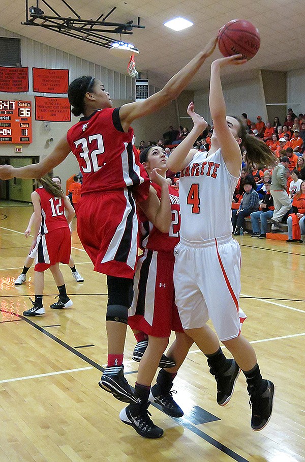 Staff Photo Randy Moll
Tahlon Hopkins, Farmington junior forward, blocks a shot Jan. 31 by Gravette’s Maddie Foster. Gravette will open play in the 4A-1 District Tournament at 4 p.m. today against Gentry. The District Tournament is being played in Farmington. The host Lady Cardinals will not play until 4 p.m. Friday.
