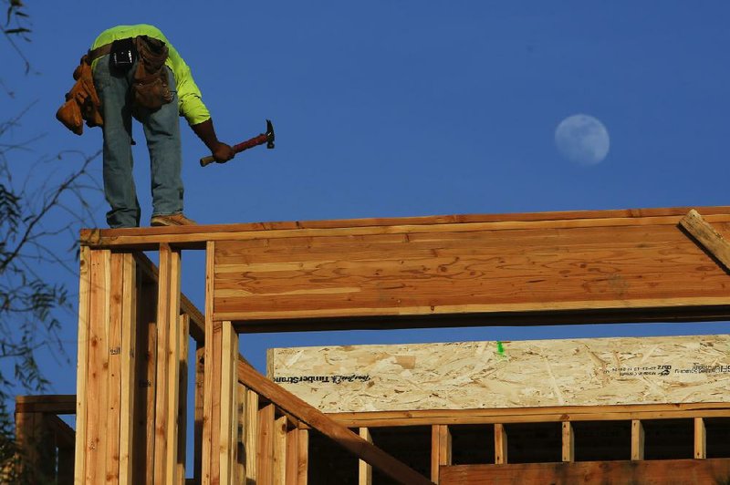 A worker frames a new home last week at a Toll Brothers Inc. development in Lake Forest, Calif. The National Association of Home Builders/Wells Fargo sentiment gauge slumped this month as winter weather slowed homebuyer traffic. 