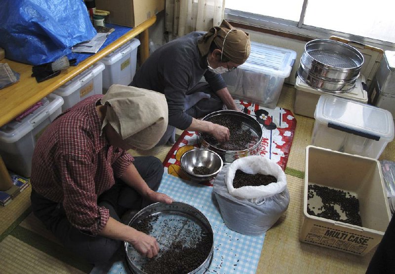 Workers help with a fair-trade coffee roasting and sales project last month at NPO Moyai in Tokyo. The group helps homeless people in Tokyo and others fallen on hard times find housing and other support and get back on their feet. 