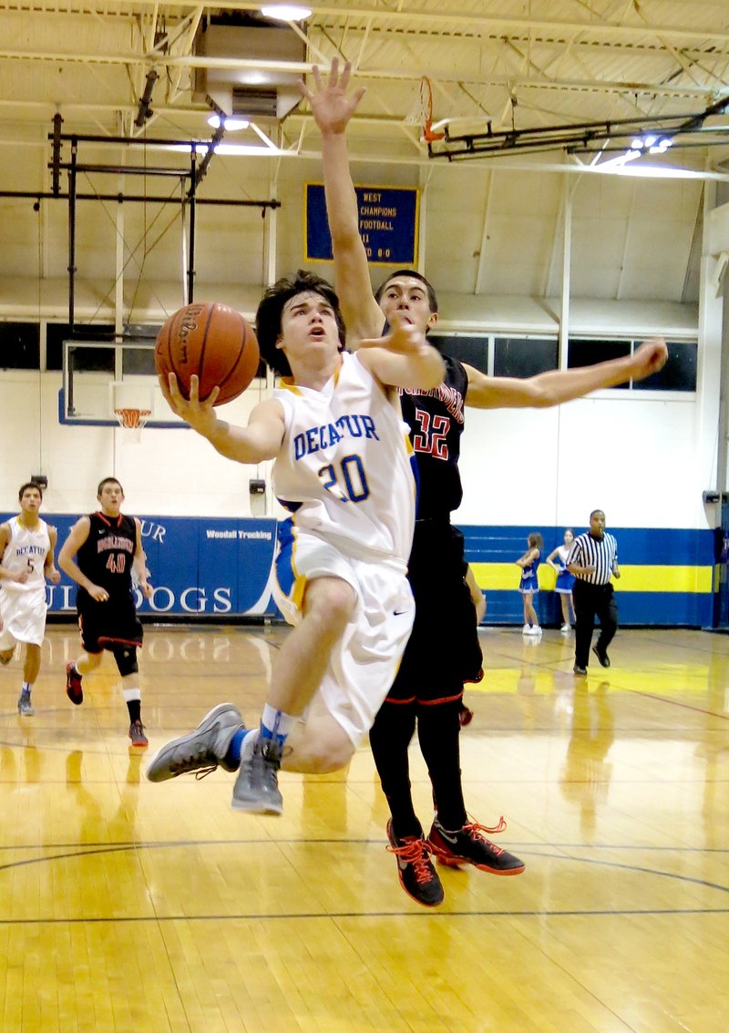 Photo by Randy Moll Terry Kell, a junior guard for Decatur, goes up for a shot in play against Eureka Springs on Tuesday, Feb. 11, 2014, at Decatur High School.