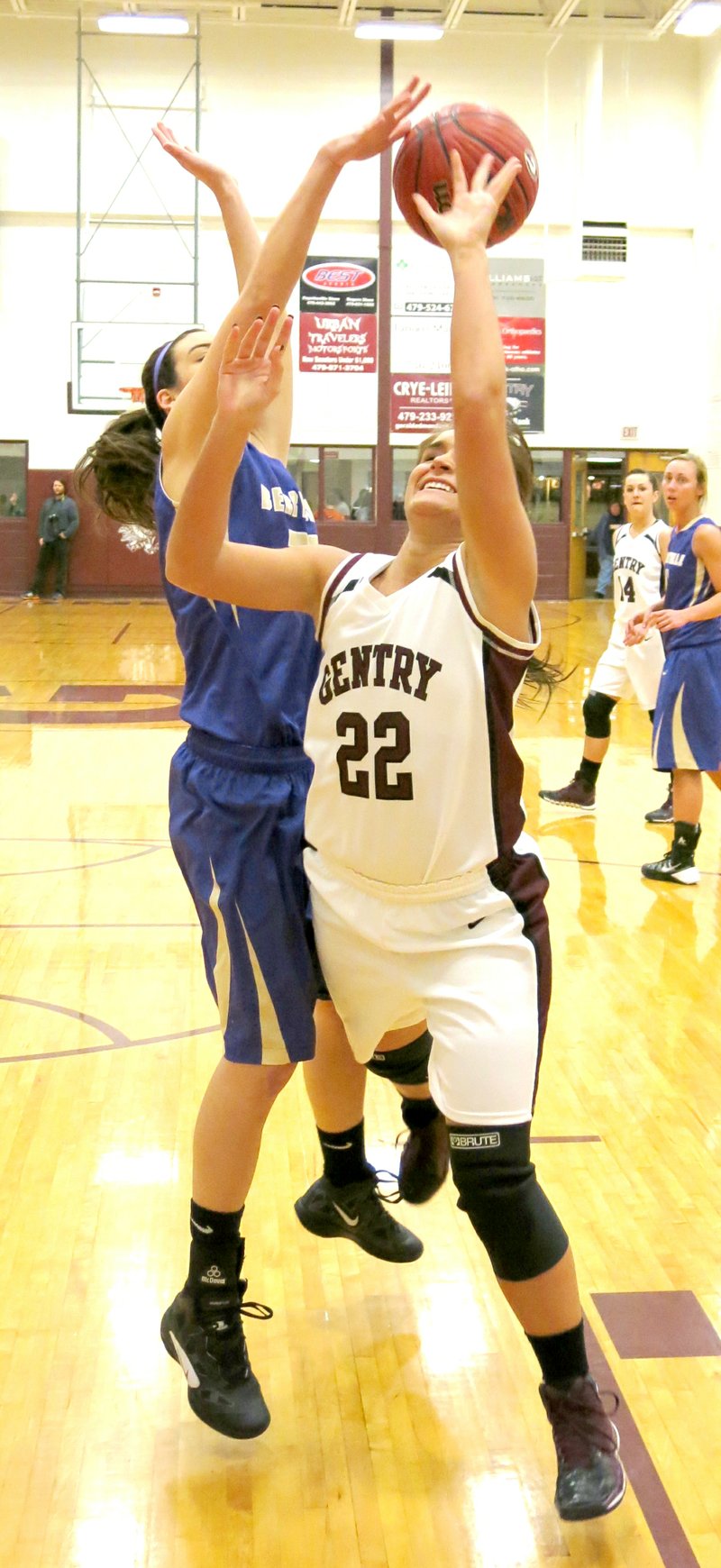Photo by Randy Moll Aspen Cripps, of Gentry, is fouled under the basket by a Berryville defender during play at Gentry High School on Friday.