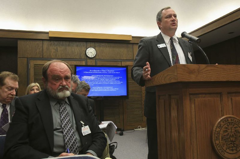 Academics Plus Charter School Executive Director Rob McGill (right) speaks Wednesday morning as Pulaski County Special School District Superintendent Jerry Guess listens during a meeting of the State Charter Authorizing Panel. the panel approved a 200-student expansion for Academics Plus charter school. 