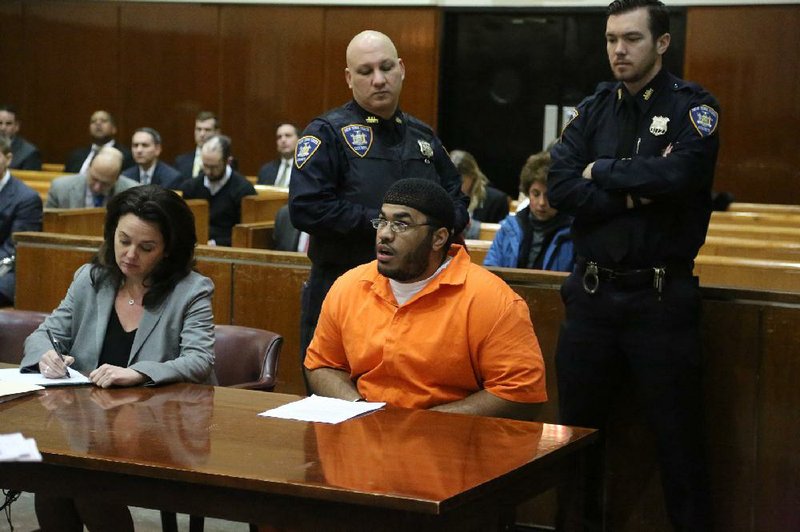 Jose Pimentel (second from right) appears Wednesday in a courtroom in New York, where he pleaded guilty to a terrorism charge less than a week before his scheduled trial. Pimentel was accused of building homemade bombs to wage holy war in New York City. 