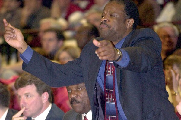 Arkansas' assistant coach Mike Anderson calls a play to the team as head coach Nolan Richardson sits on the bench during the second half of their loss to Mississippi State on Wednesday, Feb. 27, 2002 in Starkville, Miss. 