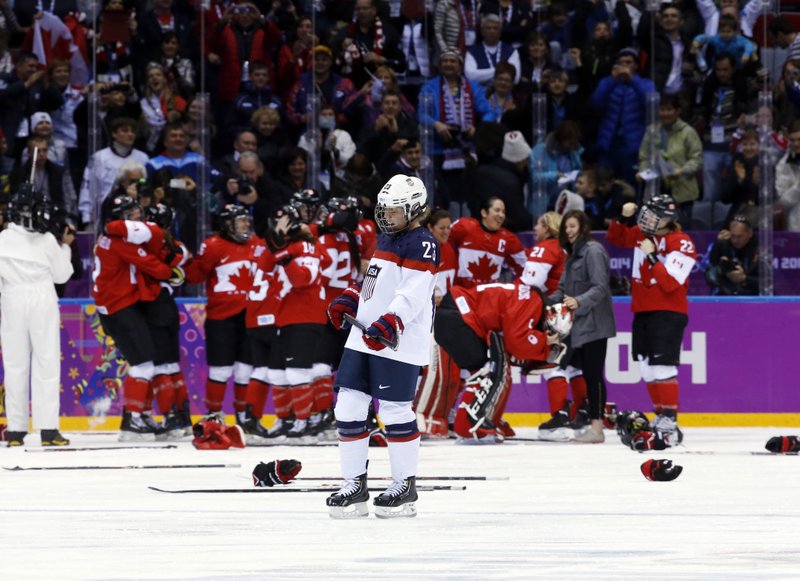 Michelle Picard of the United States (23) skates back to the bench after Canada scored in overtime to win the women's gold medal ice hockey game 3-2 at the 2014 Winter Olympics, Thursday in Sochi, Russia.