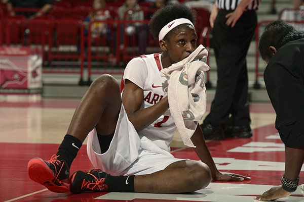Arkansas senior Keira Peak puts a towel to her bloody lip in the first half against Vanderbilt Thursday, Feb. 20, 2014 at Bud Walton Arena in Fayetteville. Peak fell to the court while driving to the basket scoring and getting the foul.