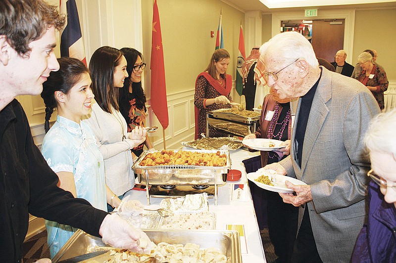 Students serve Daniel Grant, right, president emeritus of Ouachita Baptist University, during the the 2014 International Food Festival at OBU on Tuesday night. Grant’s namesake, the Grant Center for International Education on the OBU campus, is one of the sponsoring organizations of the festival, which celebrates the diversity of the international student body.