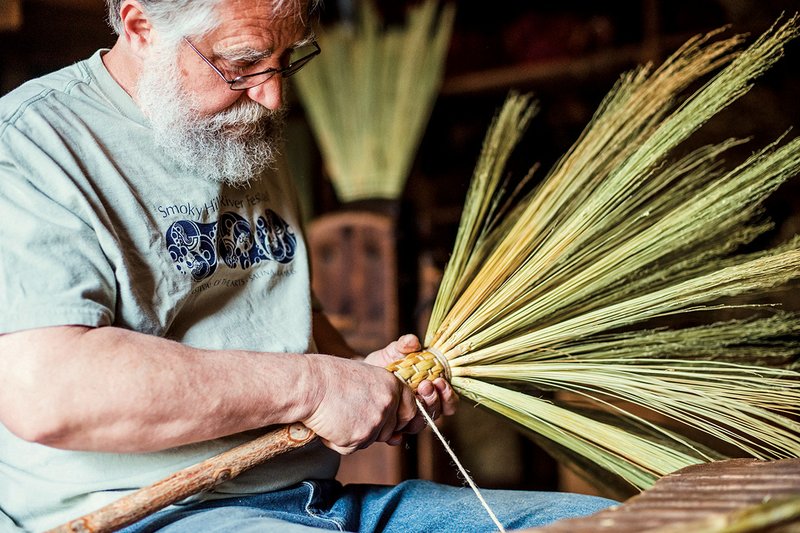 Jerry Lovenstein of Mountain View works on weaving the tops of the broom corn he has attached to a sassafras handle.