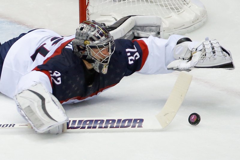 USA goaltender Jonathan Quick dives for the puck during the second period of the men's semifinal ice hockey game at the 2014 Winter Olympics on Friday in Sochi, Russia.