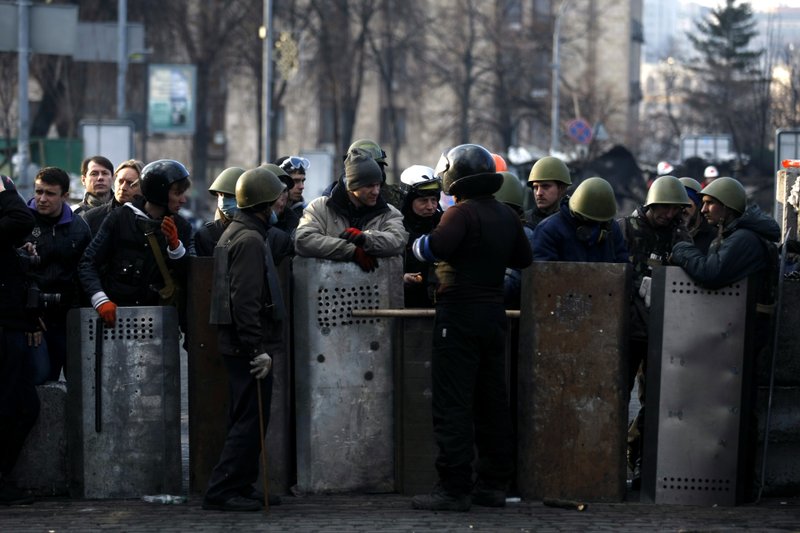 Anti-government protesters man a barricade on the outskirts of Independence Square in Kiev, Ukraine on Friday. In a day that could significantly shift Ukraine’s political destiny, opposition leaders signed a deal Friday with the country’s beleaguered president that calls for early elections, a new constitution and a new unity government. 