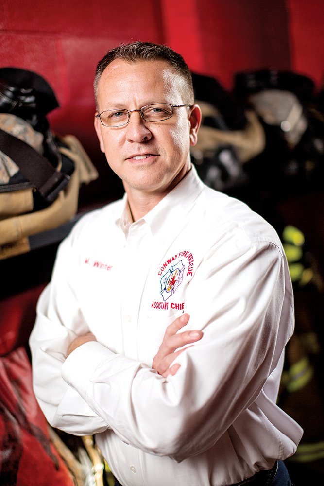 Mike Winter was hired this month as the new Conway fire chief, although his shirt still says “assistant chief.” Winter, who has been with the Conway Fire Department since 1995, was chosen for the job by Mayor Tab Townsell, who said Winter “has the detailed understanding and global perspective to make Conway a great chief for many years to come.” Winter’s father, Lewis, 86, was first assistant chief for the Conway Fire Department.