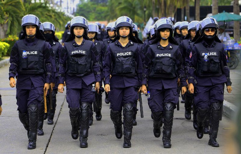 A Thai police unit made up of women marches while on guard Friday in Bangkok. 