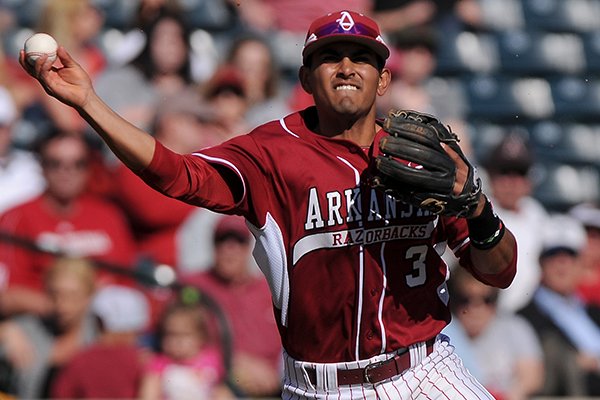 Arkansas shortstop Michael Bernal throws to first after fielding a ground ball during the game against Eastern Illinois at Baum Stadium in Fayetteville on Saturday, Feb. 22, 2014. 