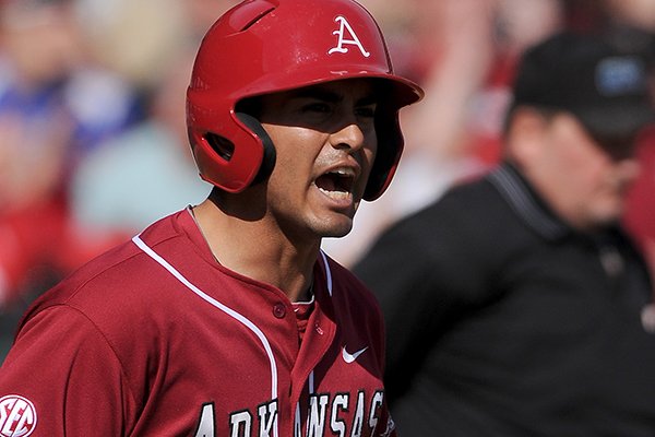 Arkansas third baseman Michael Bernal celebrates after scoring a run during the game against Eastern Illinois at Baum Stadium in Fayetteville on Saturday, Feb. 22, 2014. 