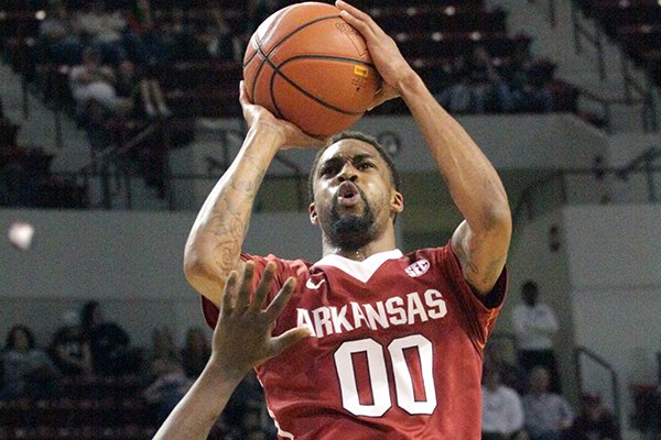 Arkansas' Rashad Madden (00) shoots over Mississippi State's I. J. Ready (15) during the second half of an NCAA college basketball game in Starkville, Miss., Saturday, Feb. 22, 2014. Arkansas won 73-69.(AP Photo/Jim Lytle)