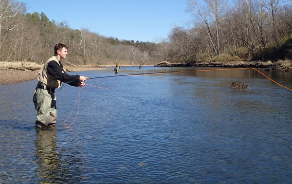 Brenden Johnson of Pea Ridge hopes for a bite while fly fishing for trout on Friday Feb. 22 2014 at the White River below Beaver Dam. Anglers could be seen up and down the river enjoying a respite from the recent winter weather.