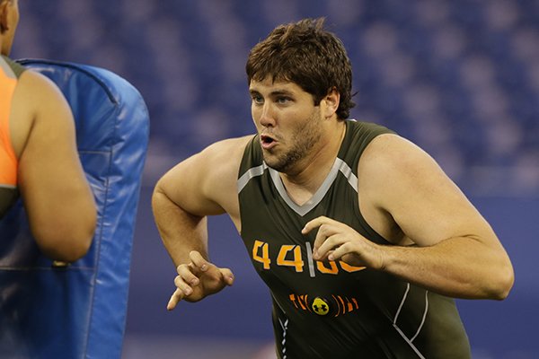 Arkansas offensive lineman Travis Swanson runs a drill at the NFL football scouting combine in Indianapolis, Saturday, Feb. 22, 2014. (AP Photo/Michael Conroy)