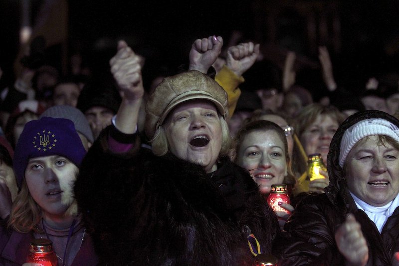 People rejoice at Independence Square in Kiev, Ukraine, Saturday, Feb. 22, 2014. Protesters took control of Ukraine's capital Saturday, seizing the president's office as parliament voted to remove him and hold new elections. 