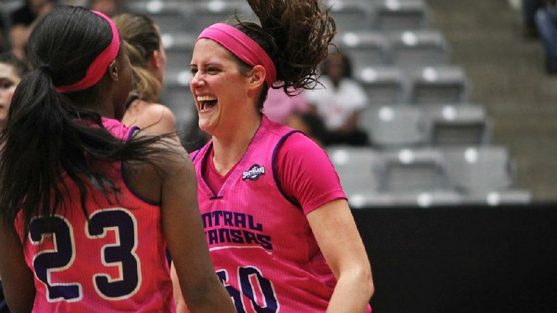 Central Arkansas senior center Courtney Duever (right) celebrates with teammate Brittany Agee after scoring two of her career-high 36 points Saturday afternoon against Oral Roberts at the Farris Center in Conway. The Sugar Bears remained in first place in the Southland Conference with a 62-54 victory. 