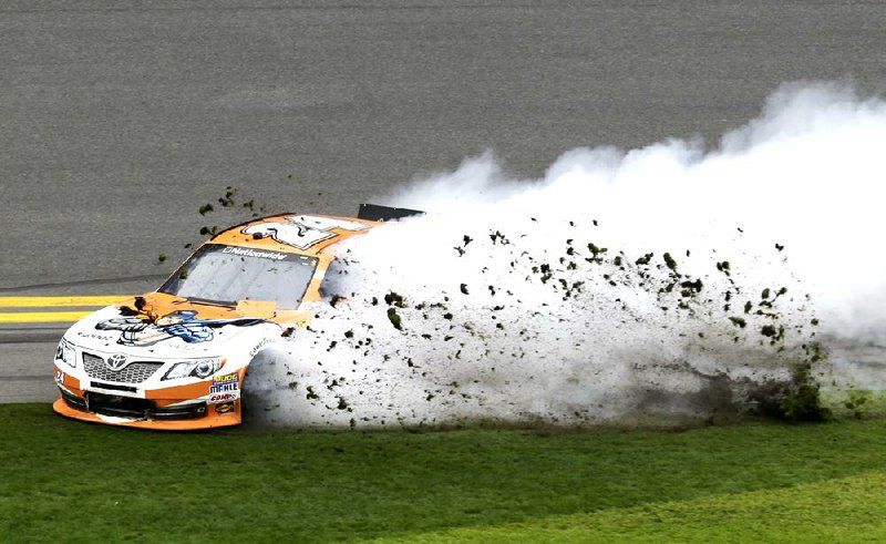 Harrison Rhodes slides through the infield grass during Saturday’s NASCAR Nationwide Series race at Daytona International Speedway. Complete results on Page 13C. 