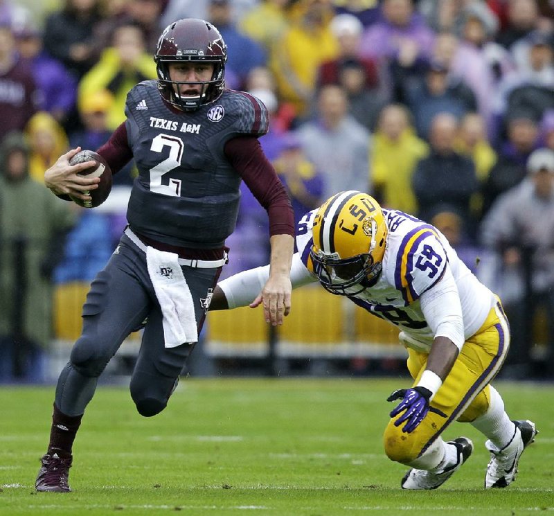 Texas A&M quarterback Johnny Manziel (left), who is listed at 5-10, 207, doesn’t think his lack of size will be an issue in the NFL, saying “I played like I’m 10 feet tall.” 