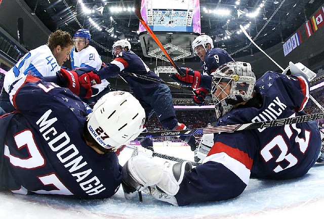 U.S. goaltender Jonathan Quick and defenseman Ryan McDonagh block a shot by Finland defenseman Kimmo Timonen (44) during the men’s bronze medal game in Sochi, Russia. Quick gave up five goals on just 21 shots over the last two periods and Finland won 5-0. 
