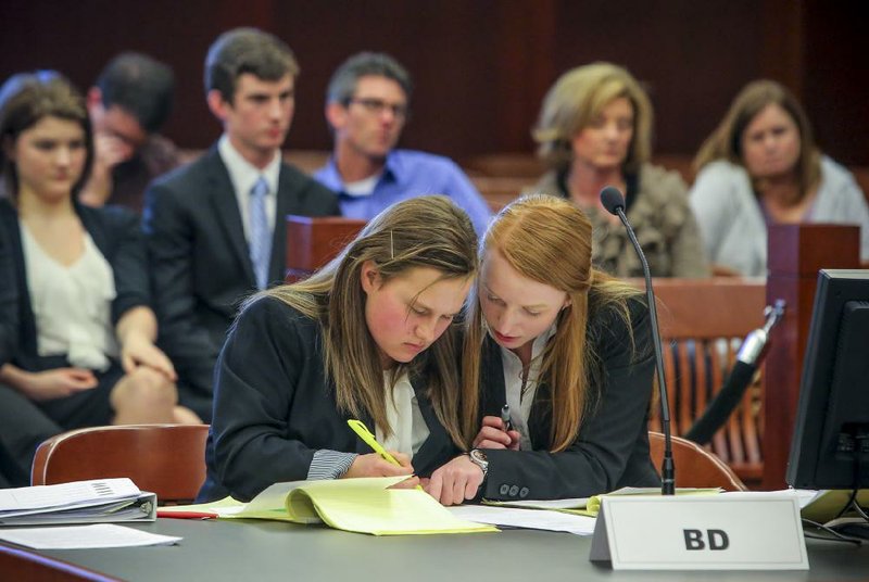 2/22/14
Arkansas Democrat-Gazette/STEPHEN B. THORNTON
Jonesboro High School prosecution team members Rachel Washam, left, and Emily Harral (Harral is cq) confer at their table as the defense team from Hope High School questions one of their witnesses during the Arkansas High School Mock Trial competition Saturday afternoon at the federal courthouse in downtown Little Rock.

